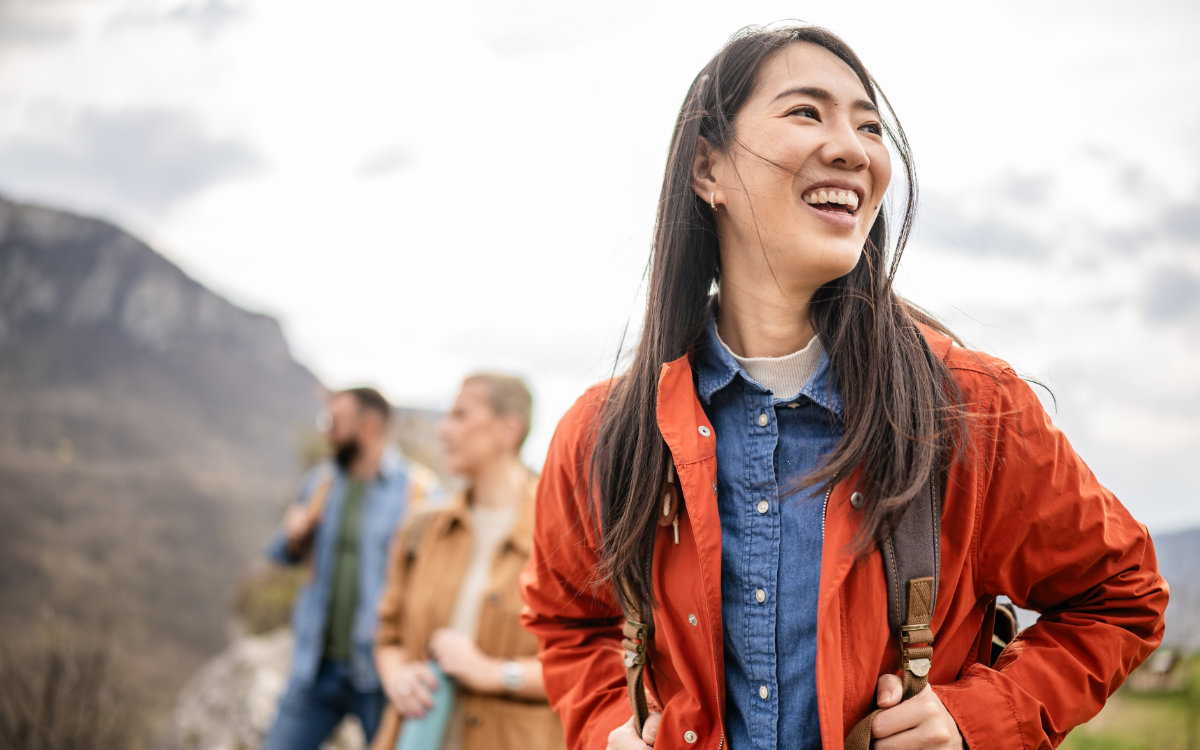 woman enjoys the outdoors, hiking with friends on a cloudy afternoon in the countryside