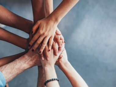 hemophilia A injection treatment | Hemophilia News Today | hands clasped in supportive huddle