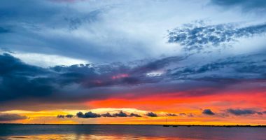 Hemophilia News Today | A photo by the author of a beautiful sunset sunset over the water at Punta Gorda, Florida. The photo displays vivid blues, oranges, and yellows.