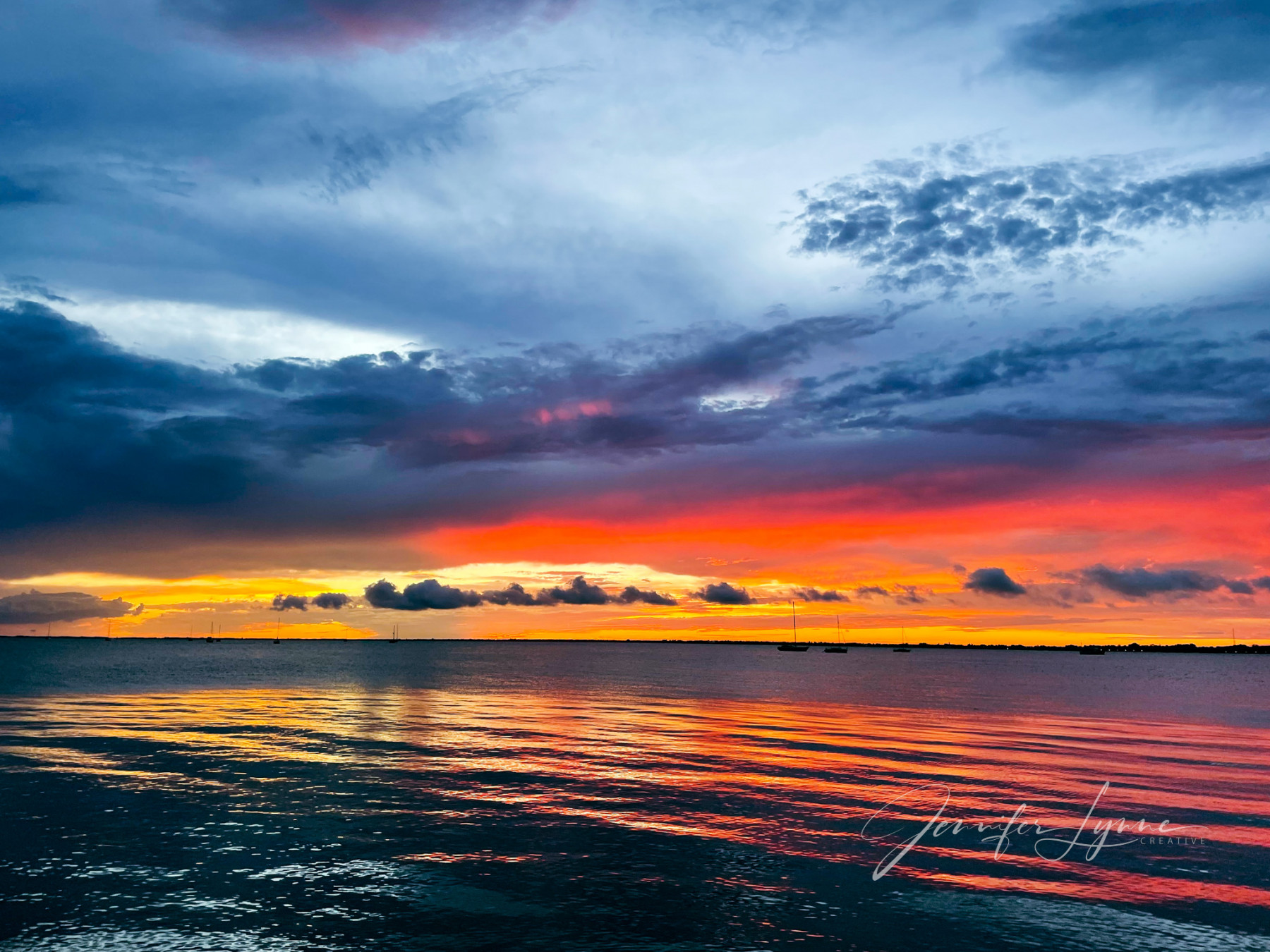 Hemophilia News Today | A photo by the author of a beautiful sunset sunset over the water at Punta Gorda, Florida. The photo displays vivid blues, oranges, and yellows.