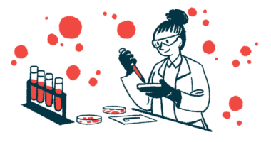 A scientist works with petri dishes in a lab, alongside a rack holding four filled vials.