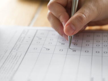 close up of person checking boxes on a form