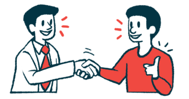 A doctor and patient shake hands while talking with one another.