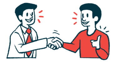 A doctor and patient shake hands while talking with one another.