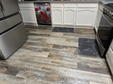 Photo of a newly tiled kitchen floor in pristine condition. 