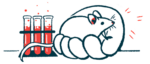 On oversized human hand holding a mouse is shown next to a trio of test tubes in a rack.
