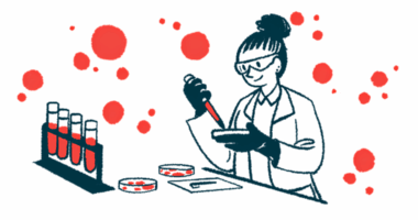 A scientist works with a petri dish in a laboratory alongside a rack of filled vials.