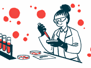 A scientist works with a petri dish in a laboratory alongside a rack of filled vials.