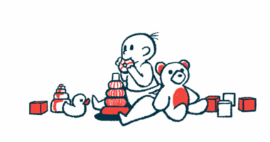 A baby surrounded by toys is mouthing one.