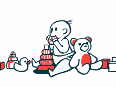 A baby surrounded by toys is mouthing one.