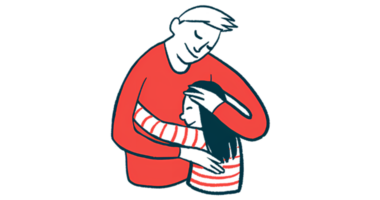 An adult cradles a child in a hug.