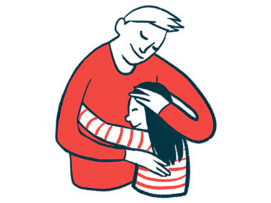 An adult cradles a child in a hug.